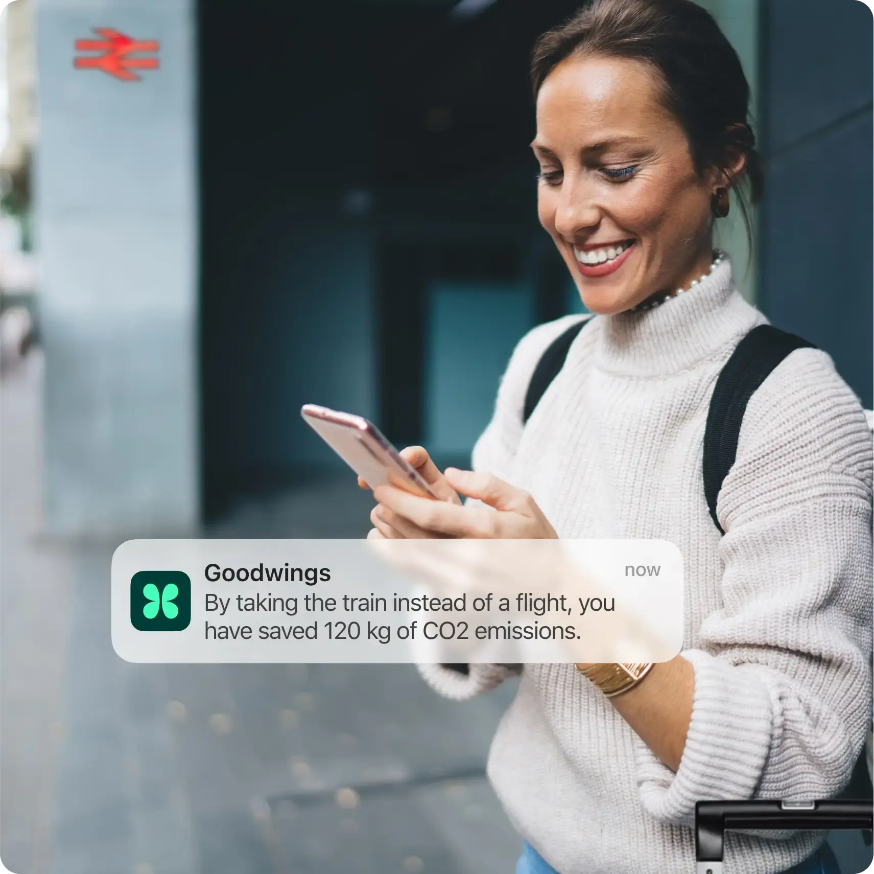 Goodwings app notification displaying environmental impact savings at train station